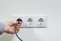 Plugging electrical cable to socket Royalty Free Stock Photo