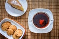 Plum biscuit cake for a cup of hot tea on a straw bedding with c