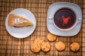 Plum biscuit cake for a cup of hot tea on a straw bedding with c