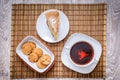 Plum biscuit cake for a cup of hot tea on a straw bedding with c