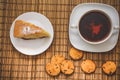 Plum biscuit cake for a cup of hot tea on a straw bedding with c