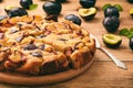 Plum biscuit cake on wooden background.