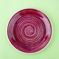 Plum color plate on the light green background