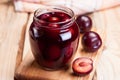 Plum compote in a glass jar.