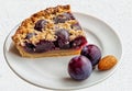 Plum Crumble Pie Slice on White Plate with Almonds Royalty Free Stock Photo