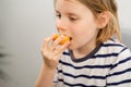 Plum feast: A youngster indulges in the succulence of a golden, ripe plum, savoring the benefits of this fruity treat Royalty Free Stock Photo