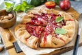 Plum Galette. Healthy homemade wholegrain fruit pie galette with plums and almonds, vegan vegetarian dessert on a stone table Royalty Free Stock Photo