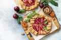 Plum Galette. Healthy homemade wholegrain fruit pie galette with plums and almonds, vegan vegetarian dessert on a stone table. Royalty Free Stock Photo