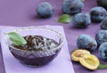 Plum jam in a glass bowl. Fruity marmalade and fresh plums. Close up view. Royalty Free Stock Photo