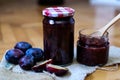Retro jar full with plum jam on decorated desk Royalty Free Stock Photo