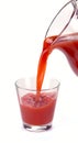 Plum juice is poured from a jug Royalty Free Stock Photo