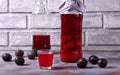 Plum liquor in a shot glass and bottles