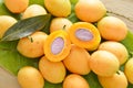 Plum mango tropical fruit produced in summer half cut on banana leaf Royalty Free Stock Photo