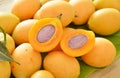 Plum mango tropical fruit produced in summer half cut on banana leaf Royalty Free Stock Photo