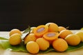 Plum mango tropical fruit produced in summer half cut on black background Royalty Free Stock Photo