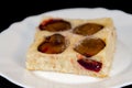 Plum-pie with cinnamon on a white plate Royalty Free Stock Photo