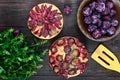 Plum pies on a dark wooden background.