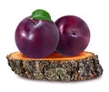 Plum on a wooden ÃÂross section of tree trunk isolated on white Royalty Free Stock Photo