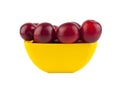 Plum in a yellow plate isolated on a white Royalty Free Stock Photo