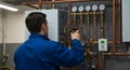 plumber adjusting valves on complex pipe system Royalty Free Stock Photo