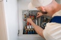 Plumber inspecting pipes in a heating system within a residential boiler room Royalty Free Stock Photo