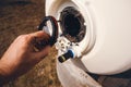 Plumber checking a boiler. Residential hot water heater service concept. Limescale. Heating element, rust and scale on boiler