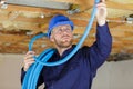 Plumber checking ceiling pipes Royalty Free Stock Photo