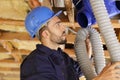 Plumber checking ceiling pipes Royalty Free Stock Photo