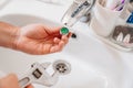 A plumber cleans a water purification filter in faucet faucets in a washbasin