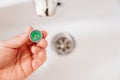 A plumber cleans a water purification filter in faucet faucets in a washbasin