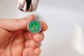 A plumber cleans a water purification filter in faucet faucets in a washbasin