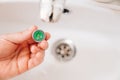 A plumber cleans a water purification filter in faucet faucets in a washbasin