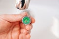 A plumber cleans a water purification filter in faucet faucets in a washbasin