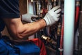 Plumber conducts an inspection and repairs the central heating system Royalty Free Stock Photo