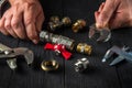 Plumber connects brass fittings with an adjustable wrench. Close-up of hand of the master during work in workshop Royalty Free Stock Photo