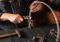 Plumber connects high pressure hose while repairing equipment. Close-up of the hand of the master during work in a workshop