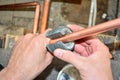 Plumber cutting copper pipe Royalty Free Stock Photo
