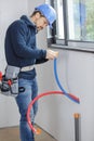 plumber cutting pipes indoors construction Royalty Free Stock Photo