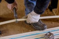 Plumber cutting in the pvc water lines pipe on new home construction