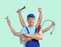 Plumber with different tools on blue background. Multitasking handyman
