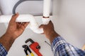 Plumber Fitting Sink Pipe In Kitchen Royalty Free Stock Photo