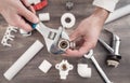 A plumber fixes a water faucet