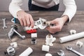 A plumber fixes a water faucet