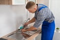 Plumber Fixing Faucet In Kitchen Sink Royalty Free Stock Photo