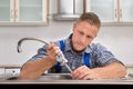 Plumber Fixing Faucet In Sink Royalty Free Stock Photo