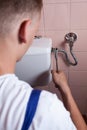 Plumber fixing a flush toilet Royalty Free Stock Photo