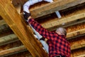 Plumber Fixing glued plastic toilet white pipe in close-up shot