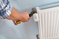 Plumber fixing radiator with wrench Royalty Free Stock Photo