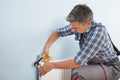 Plumber Fixing Radiator With Wrench