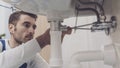 Plumber fixing a sink at home Royalty Free Stock Photo